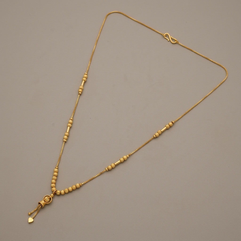 Gold-tone beaded necklace laid flat showing full design