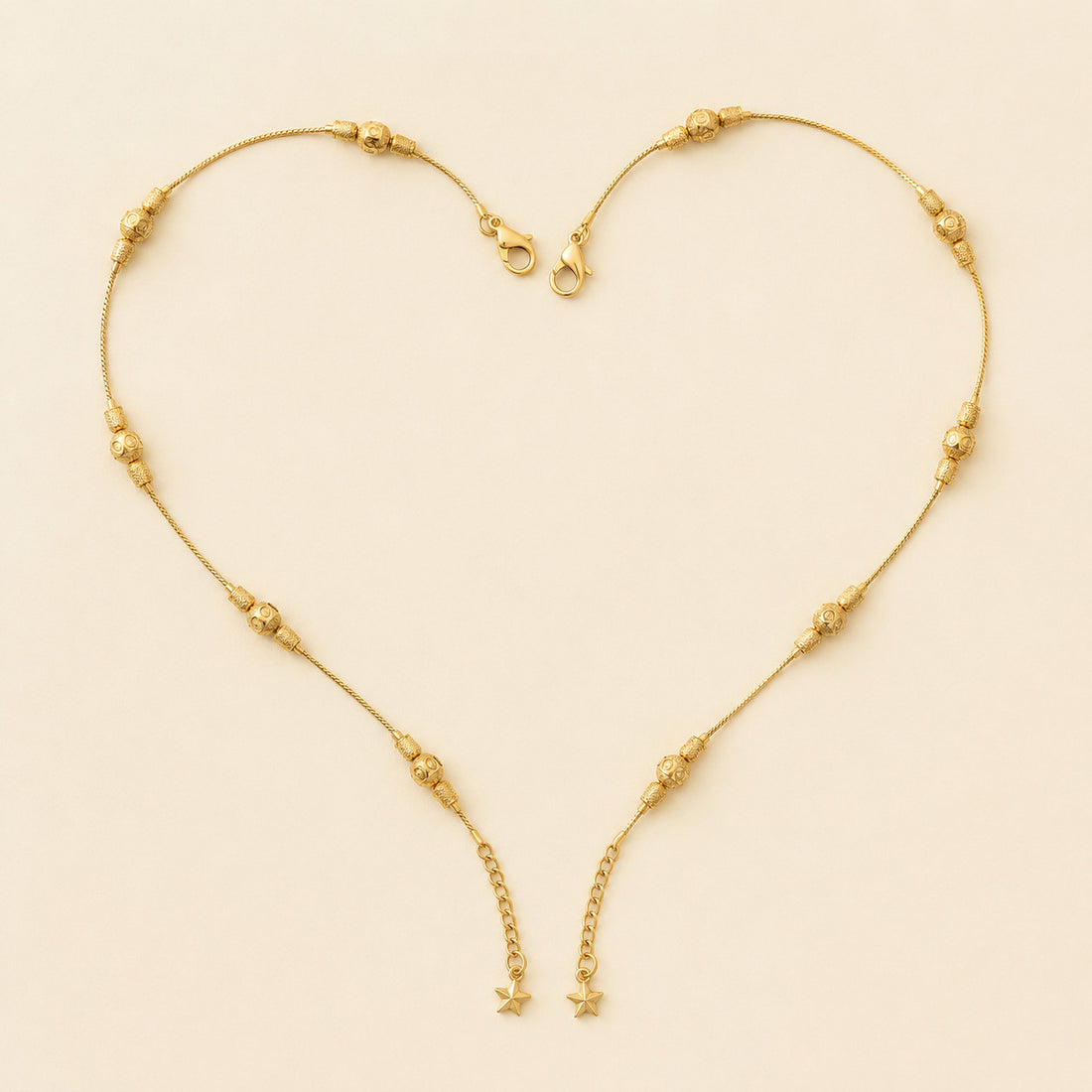 Close-up of gold-tone beaded anklet on model's ankles