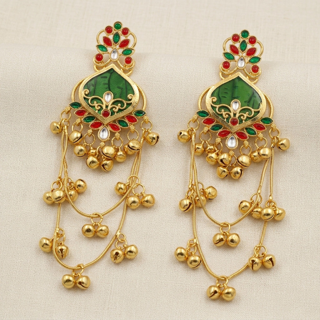 Pair of gold-tone drop earrings with green and red stone-look floral design on beige background