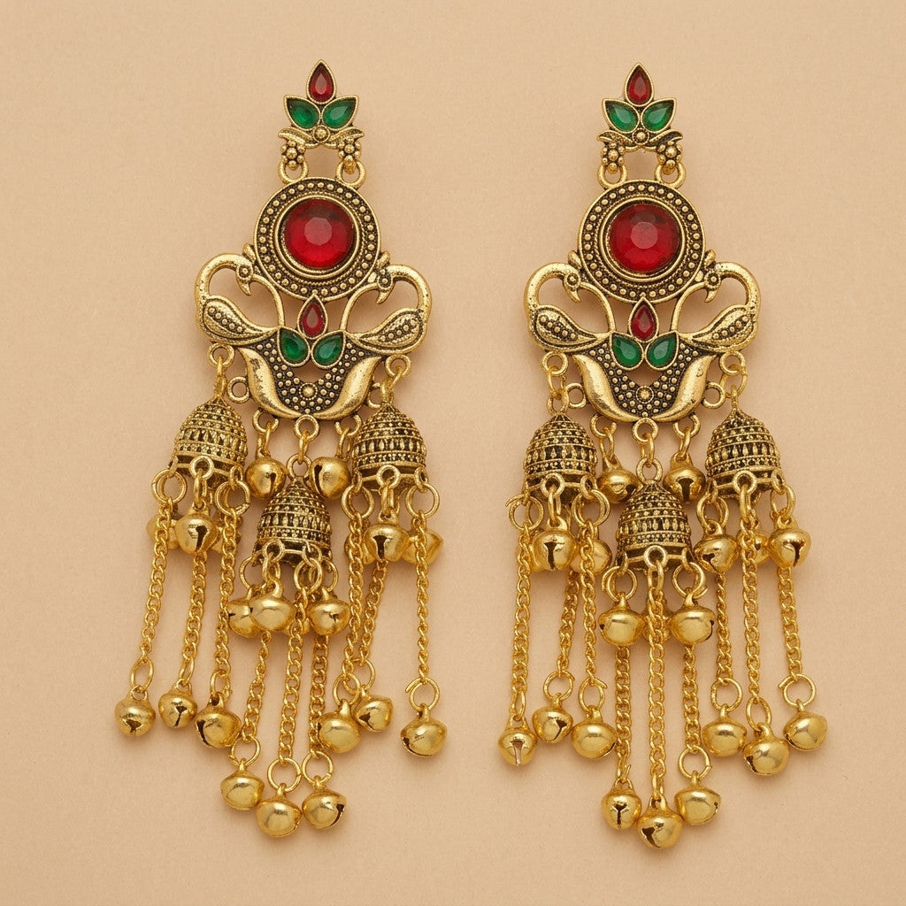 Pair of gold-tone jhumka earrings with red and green accents on plain background