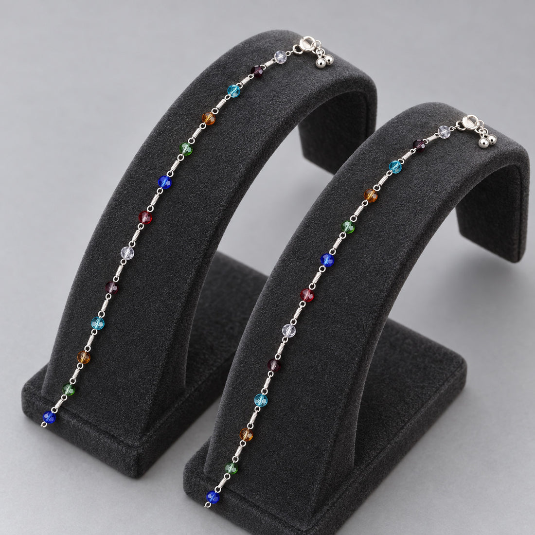 Multicolour beaded anklet on ankle with silver-tone links
