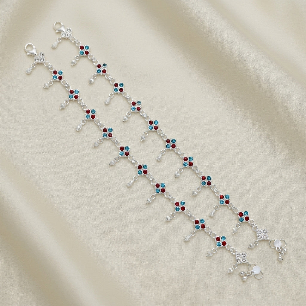Two anklets laid flat displaying full length and detailed stone-look accents with lobster clasp closure