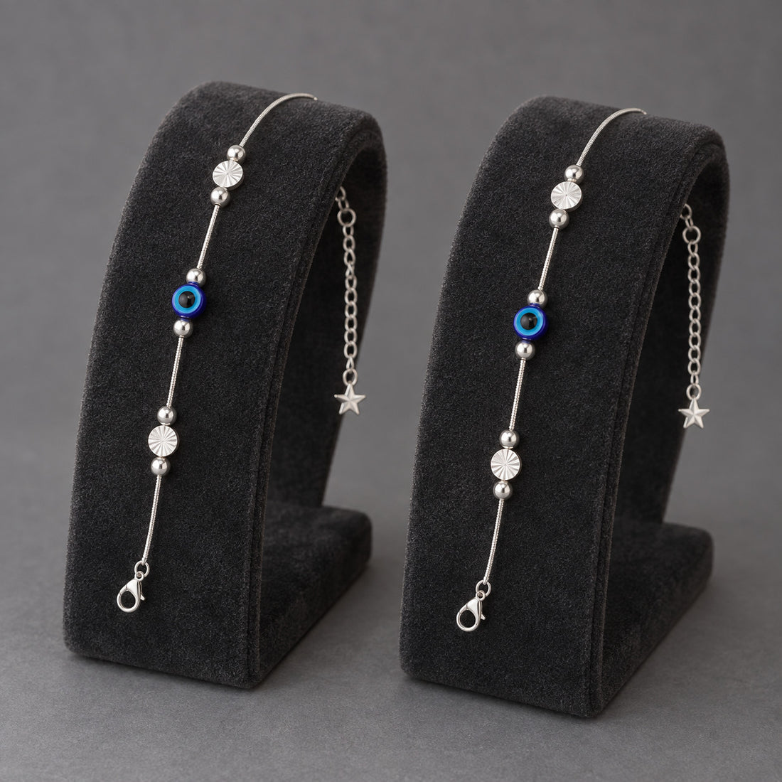 Model wearing silver-tone anklet with blue evil eye charm on ankle