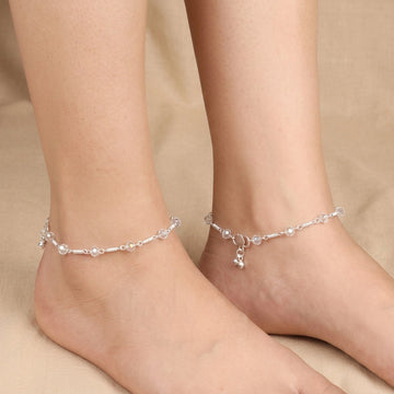 Silver-tone anklet worn on ankle with faceted crystal-look beads