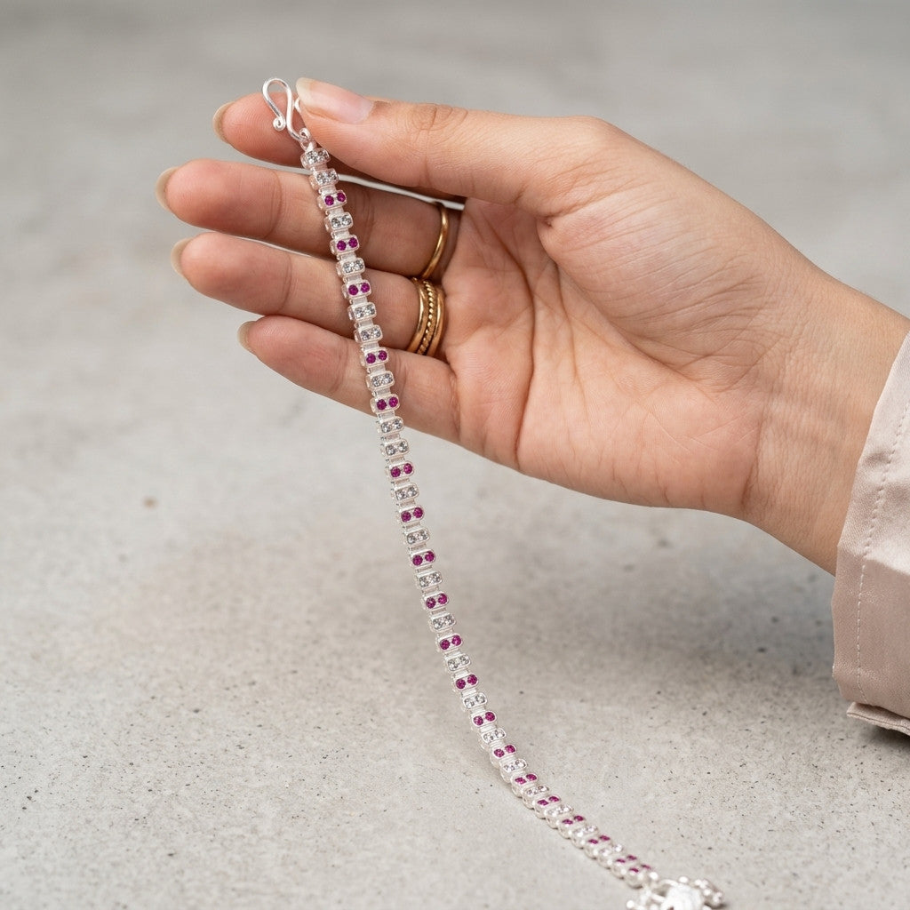 Model wearing silver-tone dual-row red and clear stone-look anklet on ankle