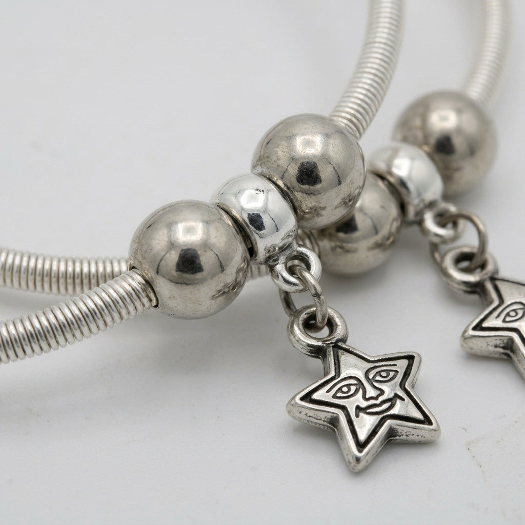 Detail view of star charm and round beads on anklet